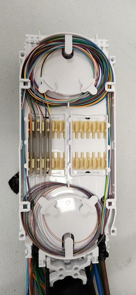 Organized fiber strands inside a splice tray